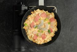 Pan of Japanese seafood pancake cooking, okonomiyaki