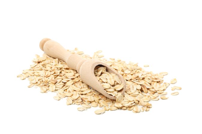 Scoop with oatmeal flakes isolated on plain background