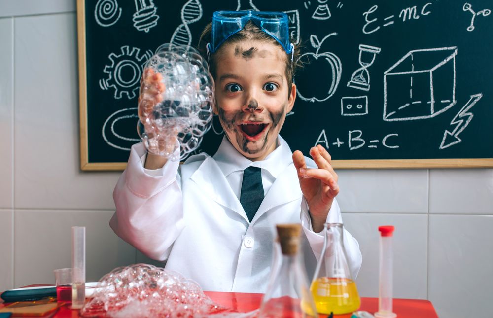 Funny boy chemist with dirty face