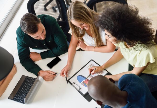 Colleagues working through statistics on table