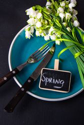 Top view of table setting for spring dinner with flowers