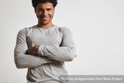 Smiling man in grey with arms crossed in studio shoot 5zlLob
