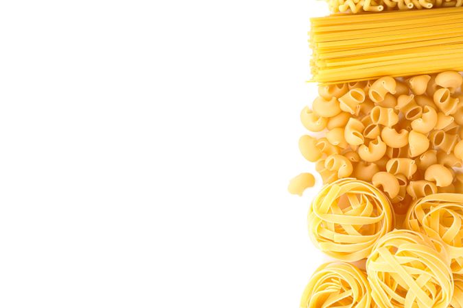 Pasta isolated on studio background, top view. Dry uncooked whole pasta