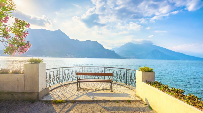 Bench on lakefront in Como Lake landscape, Bellagio Italy