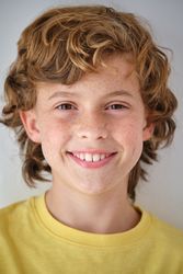 Cheerful boy with freckles on face skin