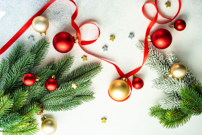 Fir on marble counter with ribbon, and red & gold baubles