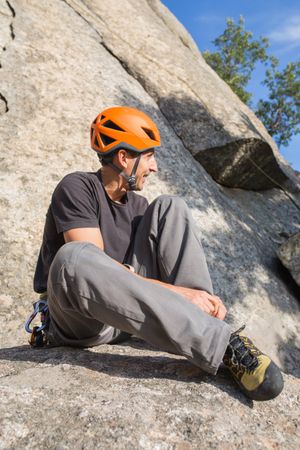 A rock climber is preparing to start climbing