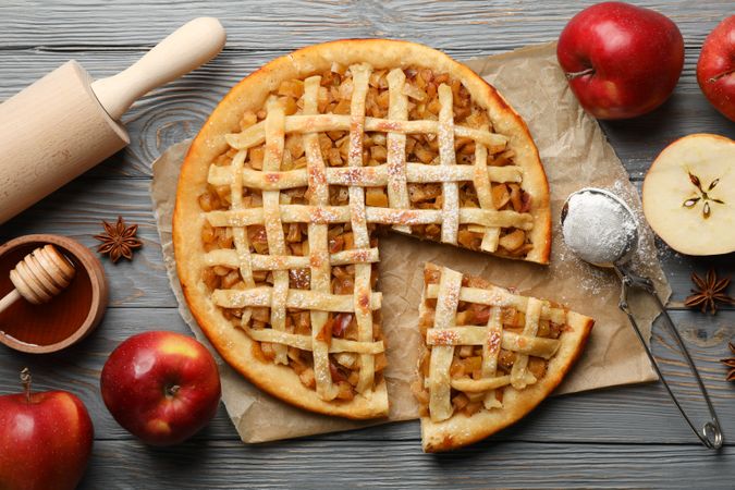 Composition with apple pie and ingredients on wooden background. Homemade food