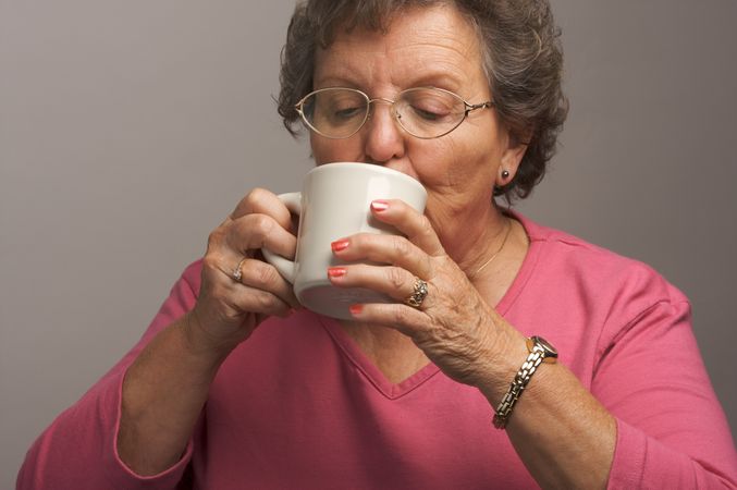 Mature Woman Enjoys Her Coffee