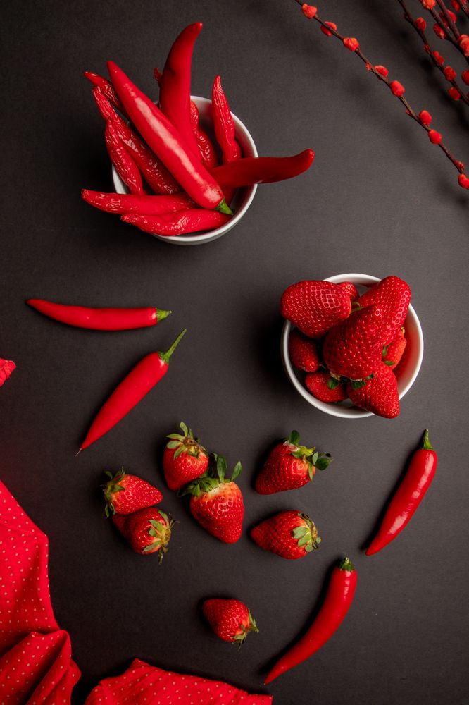 Cloth and branches near peppers and strawberries