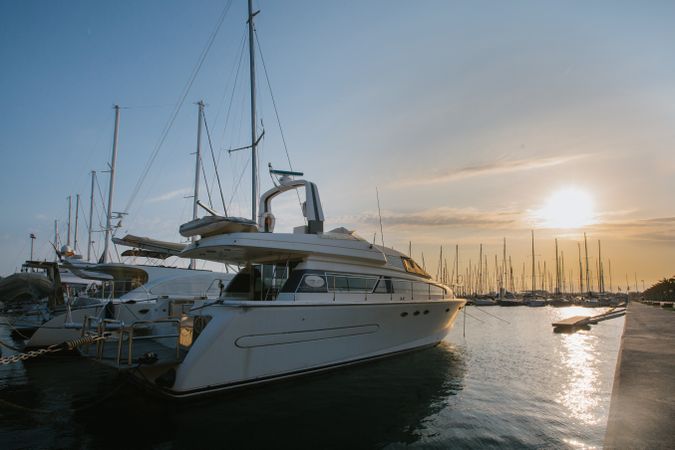 Luxury yachts in port at sunset