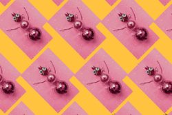 Rows of gold bauble snowman on pink and orange background