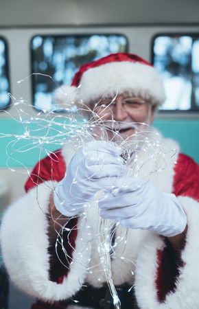 Santa Claus sitting with gifts and garland