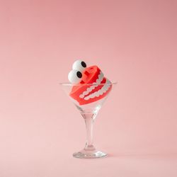 Martini glass with plastic toy teeth
