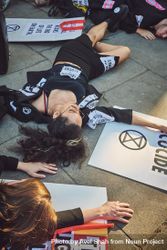 London, England, United Kingdom - September 15th,2019: Female protestor lying on street among signs 0LdXE0