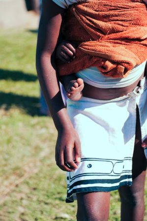 Cropped image of South African mother holding her baby with baby sling