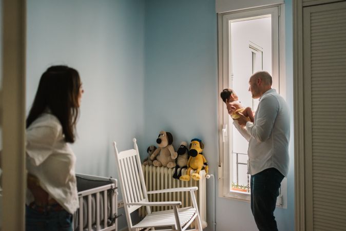 Parents talking to baby in nursery