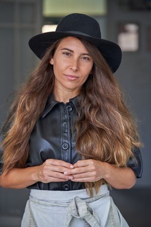 Stylish model in black hat and jacket