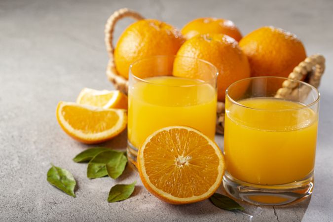 Glass with orange juice on the table.