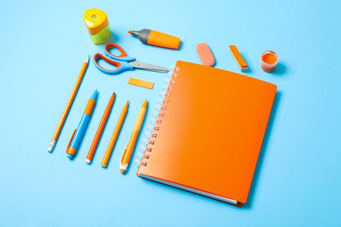 Flat lay composition with school supplies on color background, space for text
