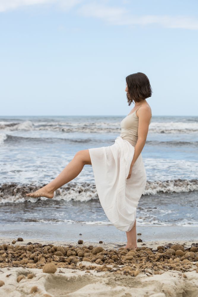 Charming young woman on shore near water