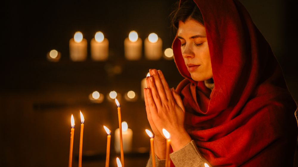 Female Parishioner hoping and Wishing with Closed Eyes keeping her heart Pure with Prayers