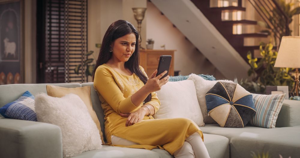 Elegant Indian Woman Using Smartphone at Home