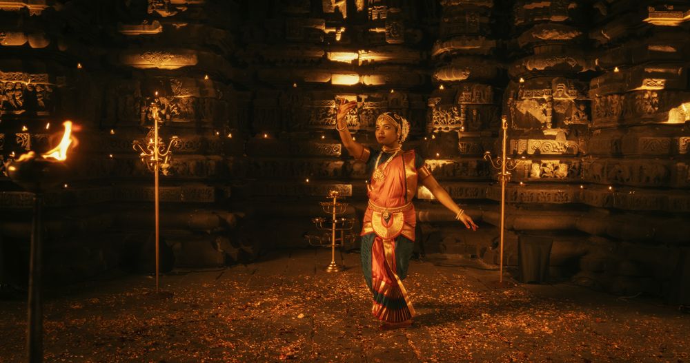 Portrait of an Active Indian Woman Engages in a Spellbinding Performance of Traditional Folk Dance Inside a Candle-Lit Temple.
