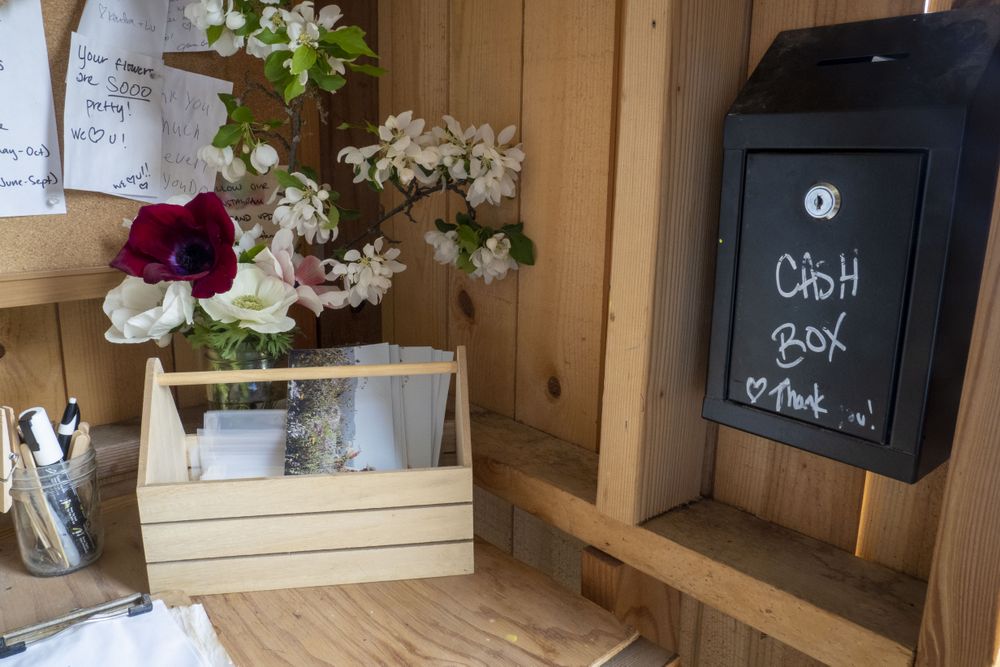 Cash box and signs on desk of small shop