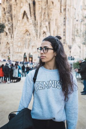 Smiling female tourist on city street