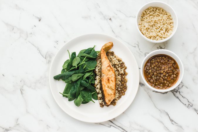Served salmon steak with beans and couscous
