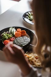 Anonymous girl eating vegan food at home