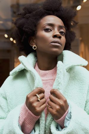 Woman wearing turquoise jacket in portrait