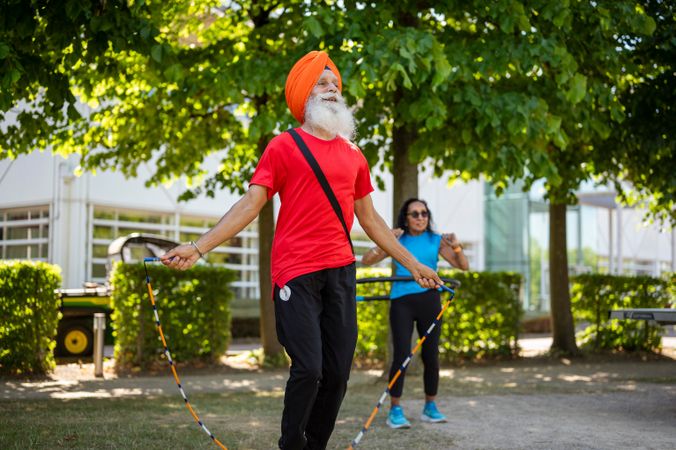 Mature Sikh couple doing cardio in public park