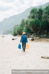 Back of man walking on beach with bucket and bag 4MQlE4