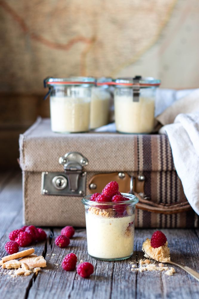 Cheesecake with raspberry in tubs on table