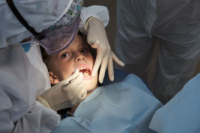Child having teeth examined by dentist
