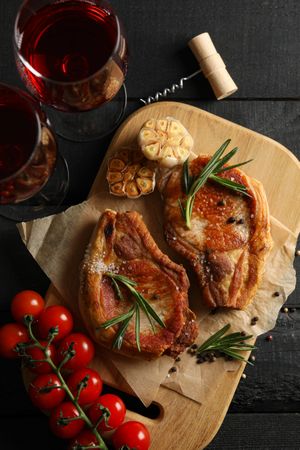 Composition with fried steaks and wine. Grilled food