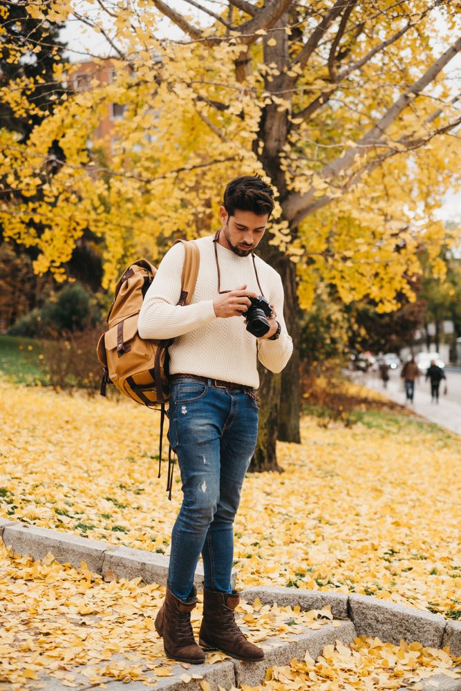 Trendy male with backpack and camera