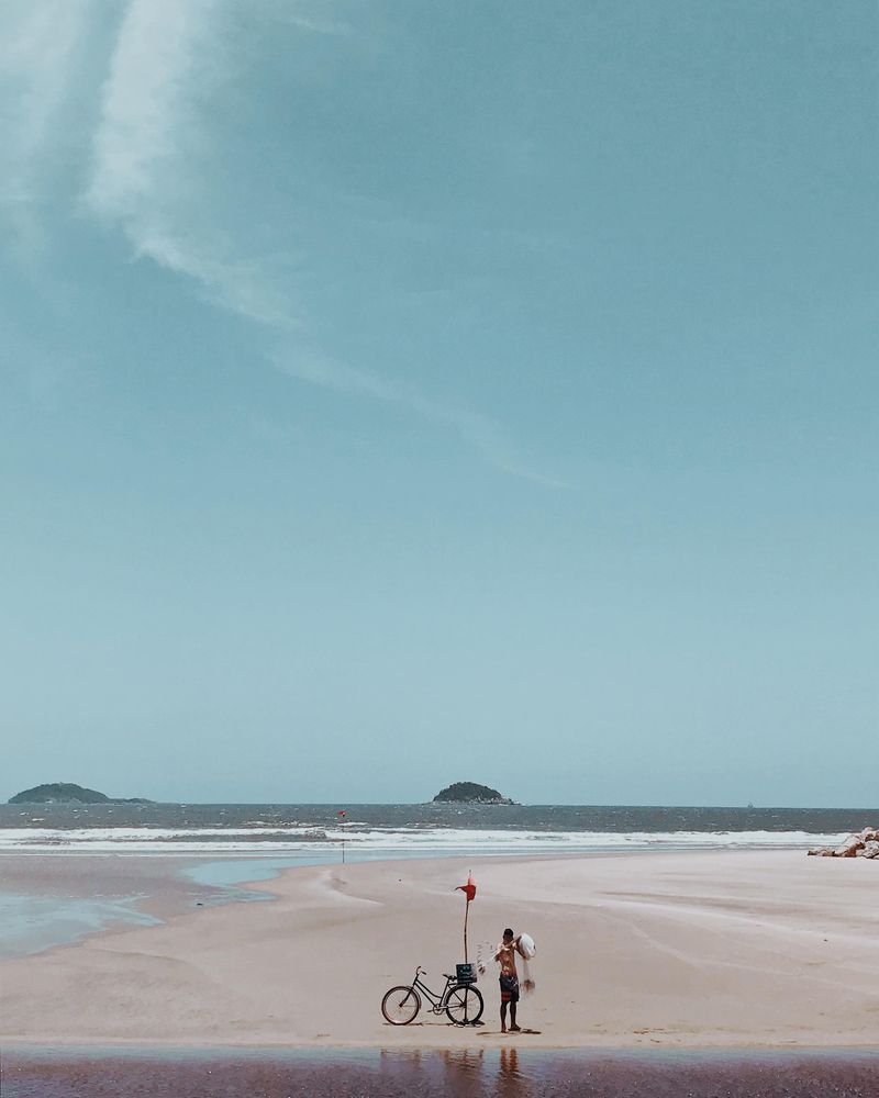 Child with a bike on seashore
