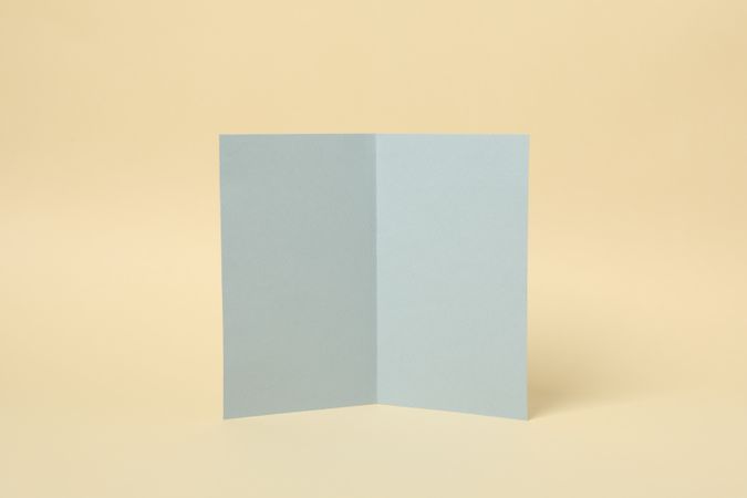 Light gray cardboard on beige background, space for text