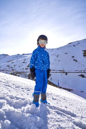 Boy spending time in snowy mountains