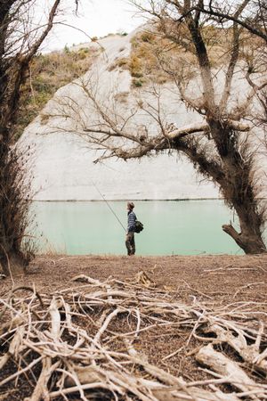 Man fishing near lake