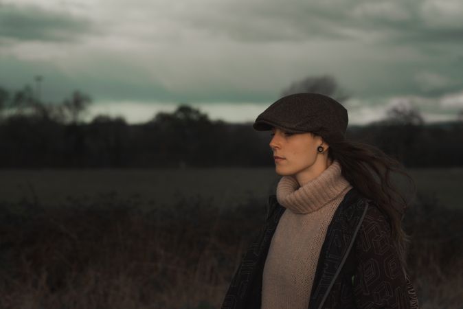 Young woman in warm clothes in forest