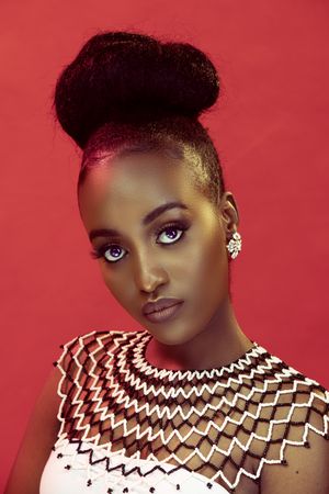 Portrait of African lady against red background