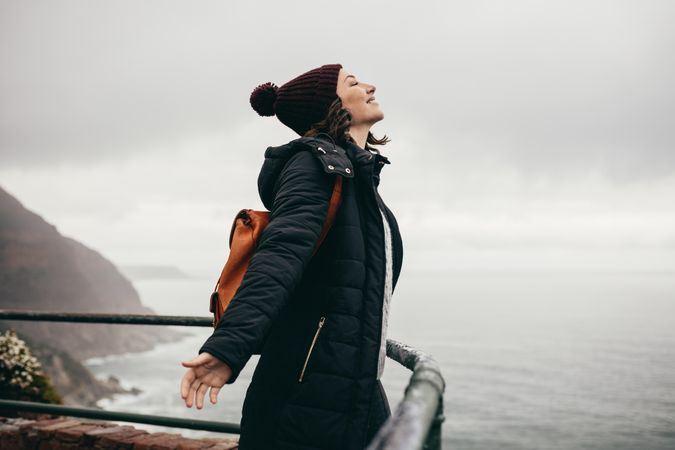 Woman enjoying standing in the fresh air on mountain top