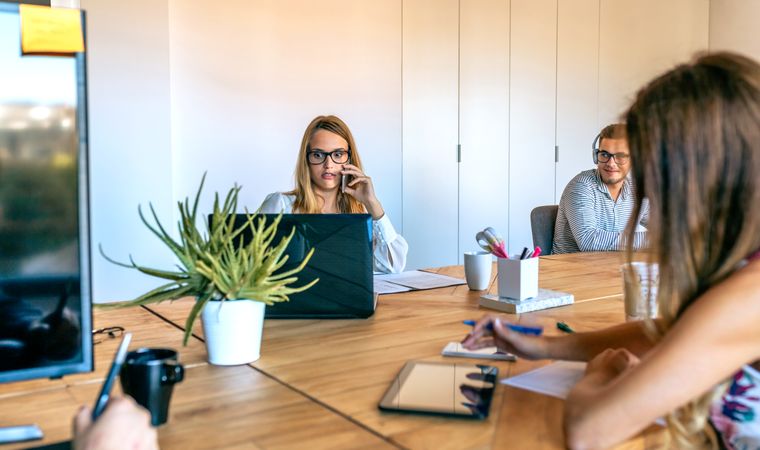 Woman working in the office surprised looking laptop