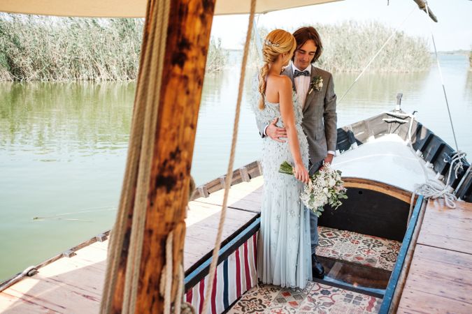 Couple holding hands while on boat