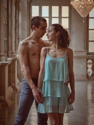 Romantic couple holding hands in hall