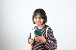 Asian School Girl Holding Mobile Phone